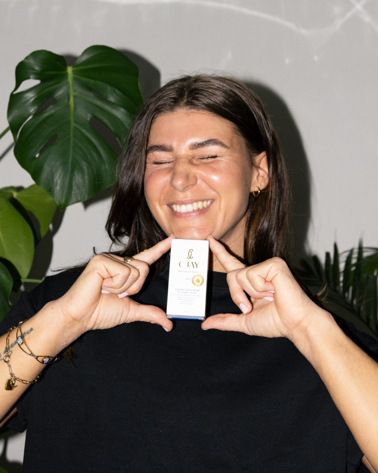 Person holding a product box with plants in the background
